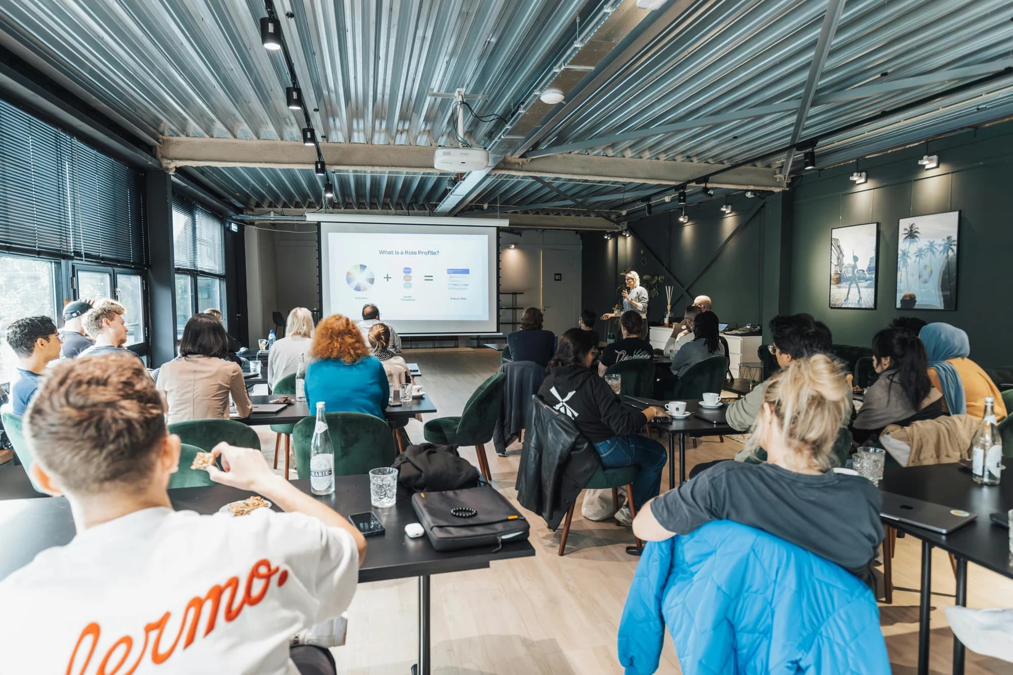 Group of attendees at a training session with a presentation on screen